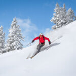 Freeride skiier riding in deep powder snow - getting ready for ski season