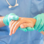 Surgeon holding patients hand