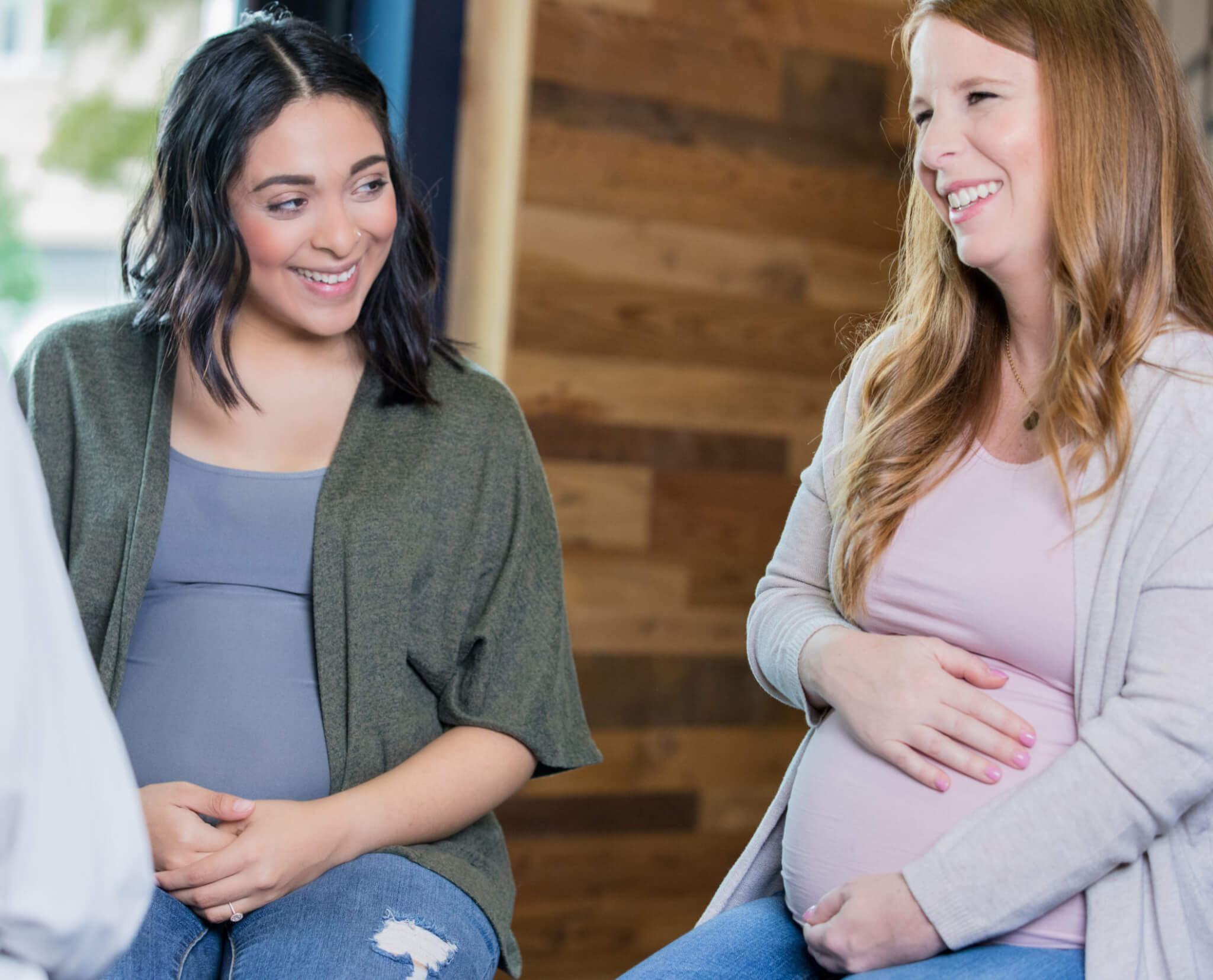 Pregnant women talking in support group