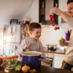 father and son making soup