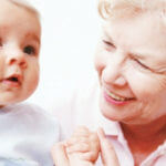 Grandma smiling with newborn