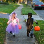 Kids dressed up and going door to door for halloween