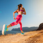 Woman running up mountain trail