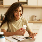 Nutritionaist holds bottle of supplements