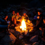 group of campers around the fire