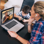 mother on video conference with doctor while watching kids from home