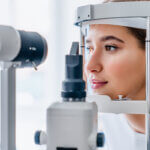 Young woman checking the eye vision in modern ophthalmology clinic