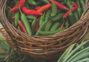 a basket of red and green chilis guide to eating local