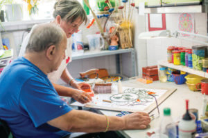 Senior Man In The Nursing Home Making A Drawing