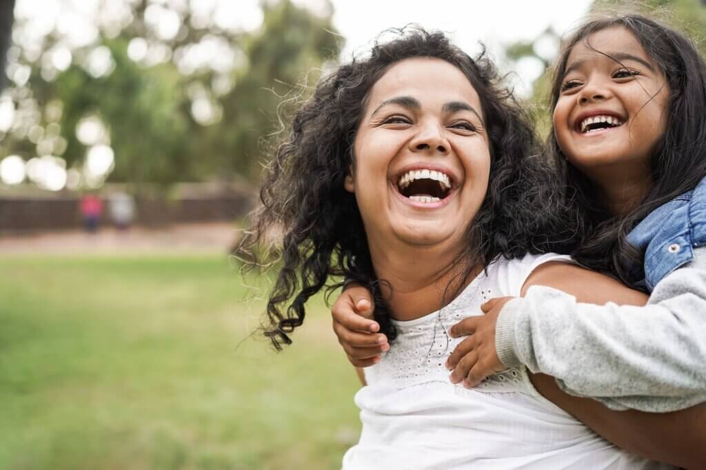 Happy mother having fun with her daughter outdoors signs of thyroid disease