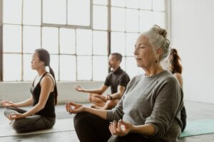 Diverse people meditating in a yoga class