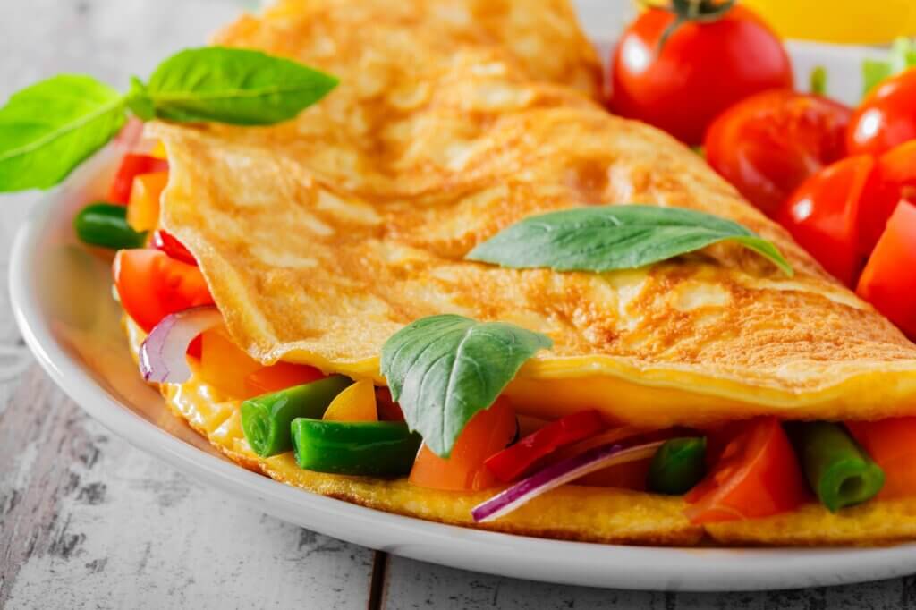 omelet with vegetables and cherry tomatoes