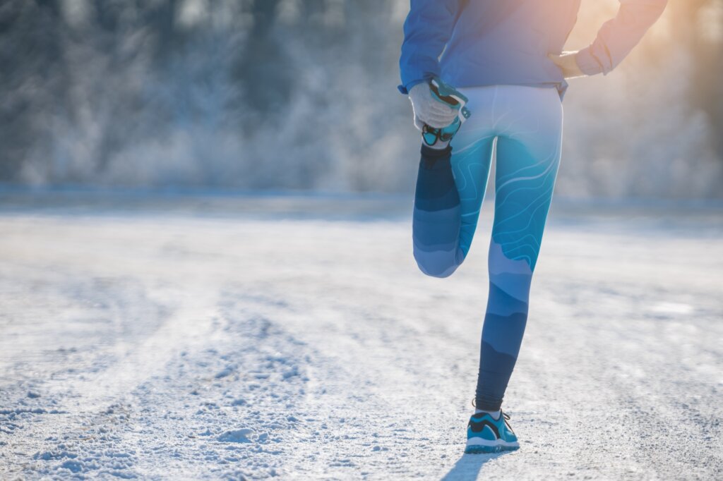 Runner stretching in winter Park. A healthy way of life